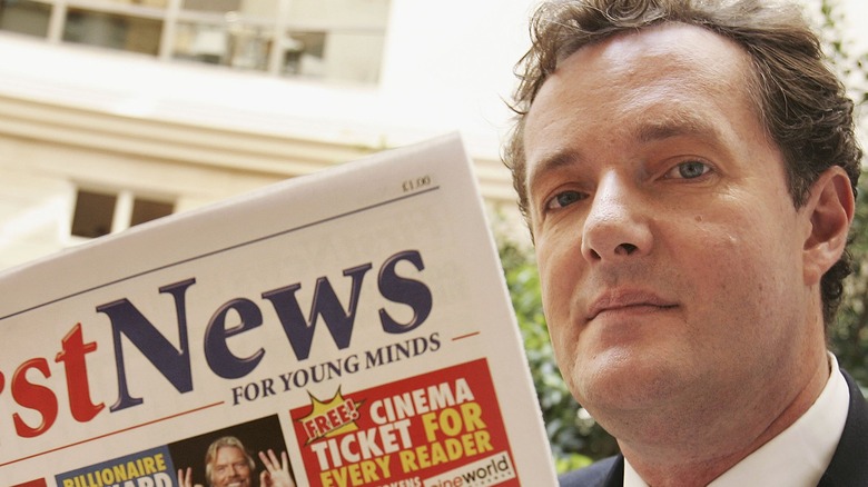 Piers Morgan reading paper