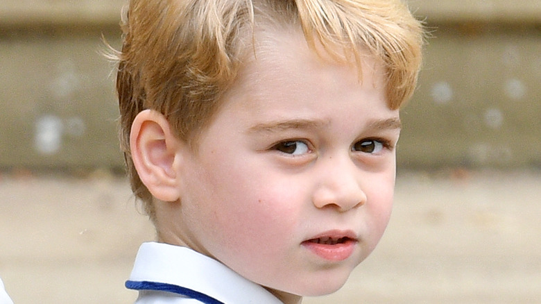 A young Prince George smiling for the camera