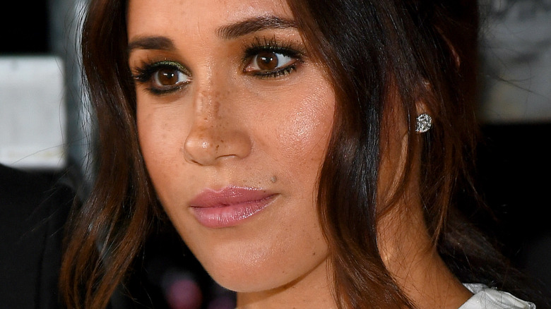 Meghan Markle with full makeup and serious expression