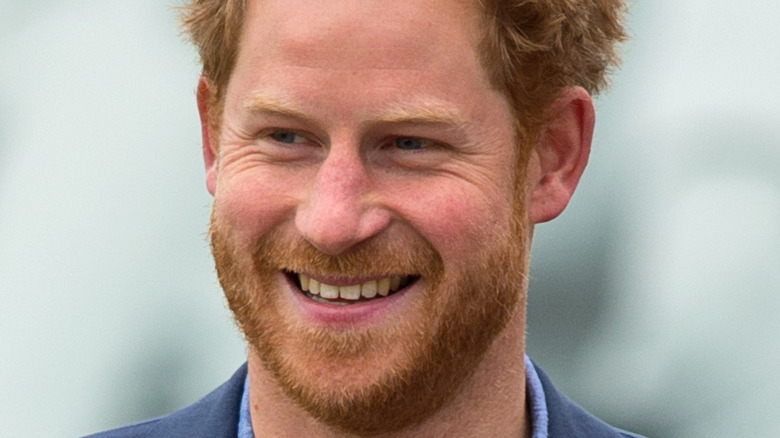 Prince Harry smiling in a suit