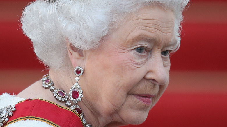Queen Elizabeth looks over her shoulder in her finery