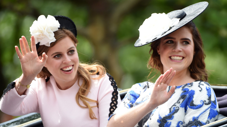 Princess Beatrice and Princess Eugenie waving from carriage during Trooping the Colour 2019