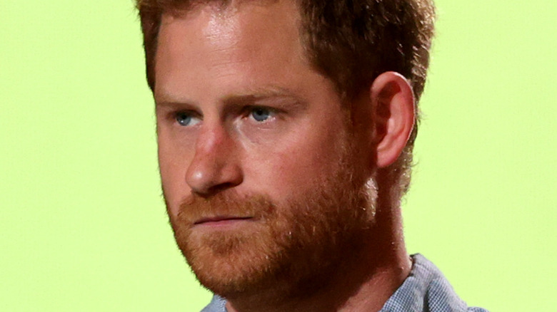 Prince Harry looking serious with facial hair