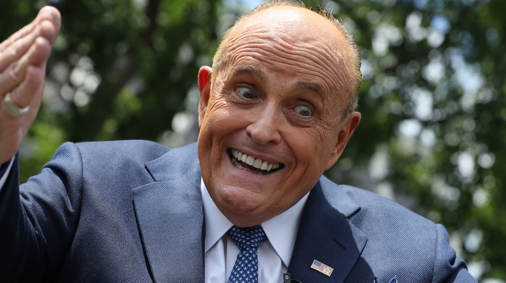 Rudy Giuliani talks to journalists at the White House.