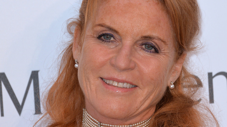 Sarah Ferguson smiles and wears red