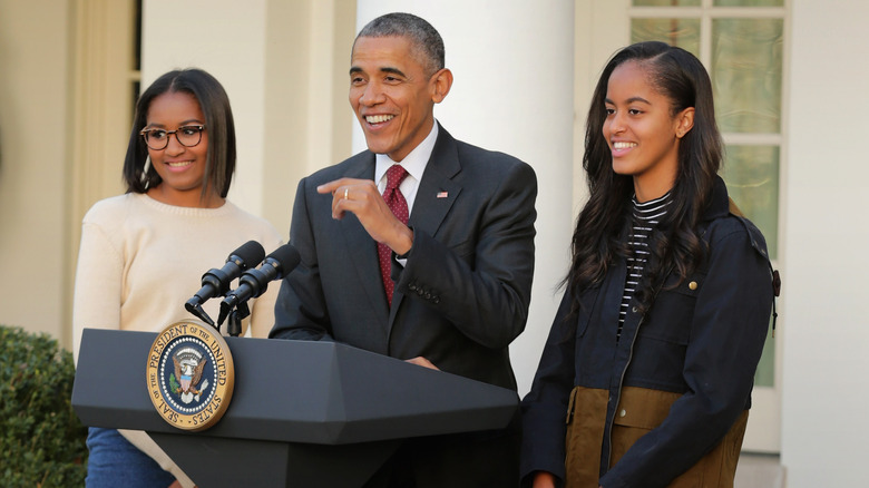 Barack Obama onstage with Malia and Sasha Obama