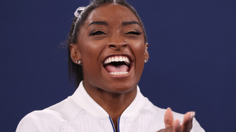 Simone Biles smiling and clapping