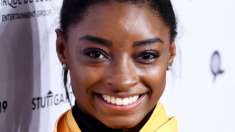 Simone Biles poses with her gold medals