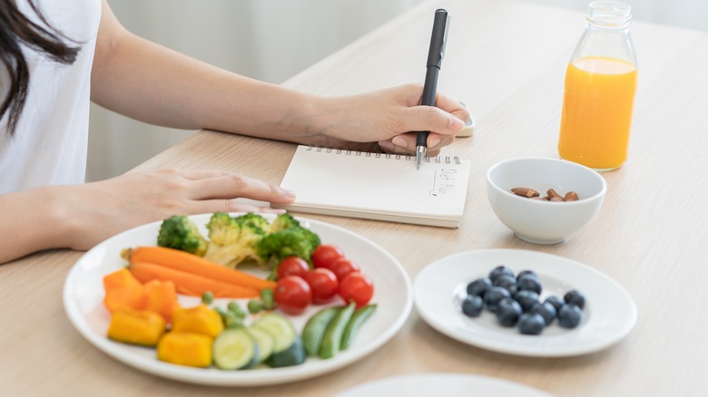 woman writing diet plan