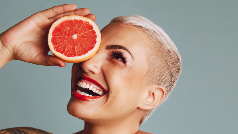 Woman holding grapefruit