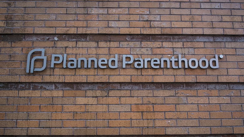 Planned Parenthood logo on a brick wall 