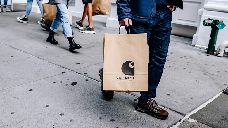 person holding Carhartt bag