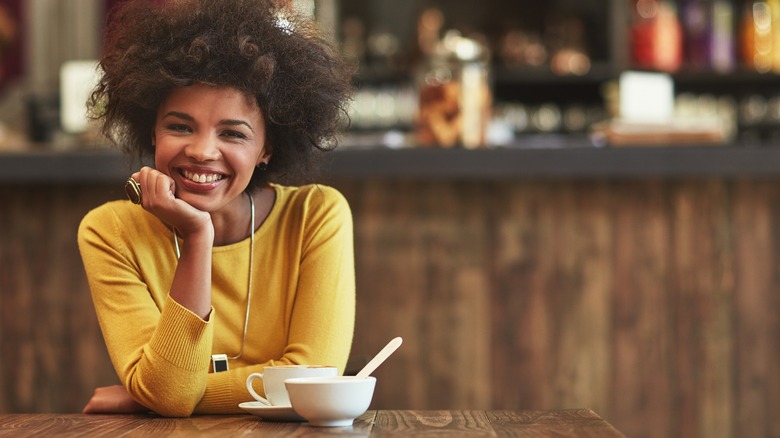 Woman smiling at cafe