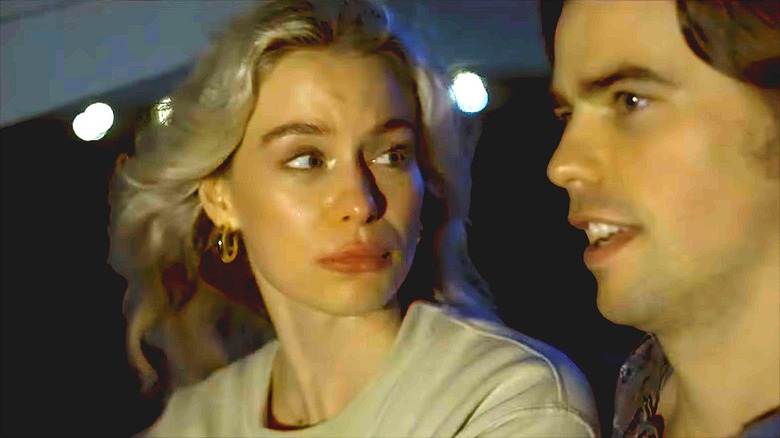 Elle Chapman in a tan shirt with gold earrings in "Shark Girl"