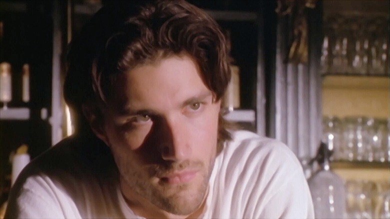 Matthew Fox in white shirt leaning on a bar counter in "Party of Five"