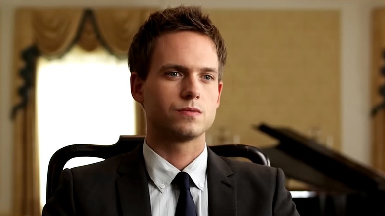 Patrick J. Adams in a black suit and tie in the series premiere of "Suits"