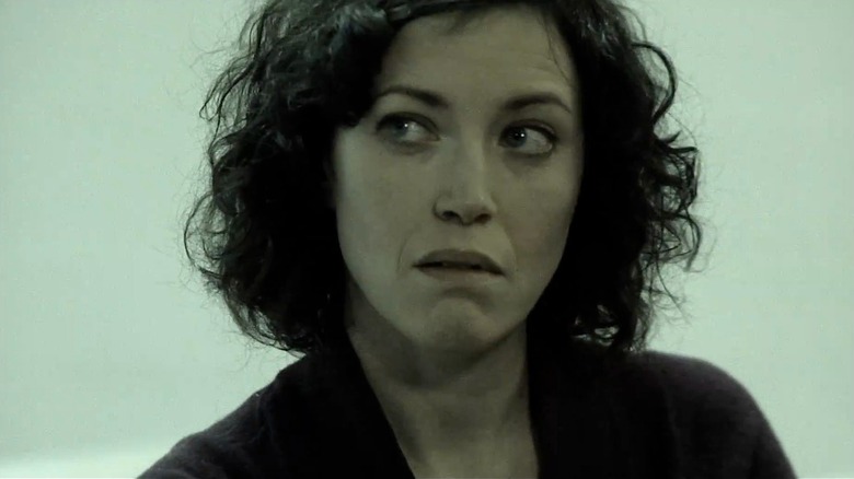 Close up of Rebecca Spence with short curly hair in "Earthlings"