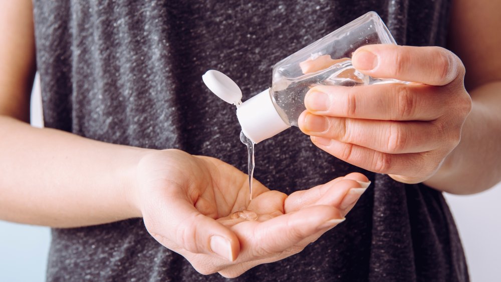 woman using hand sanitizer