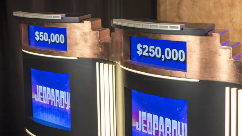 Jeopardy podiums are seen with the amounts $50,000 and $250,000.