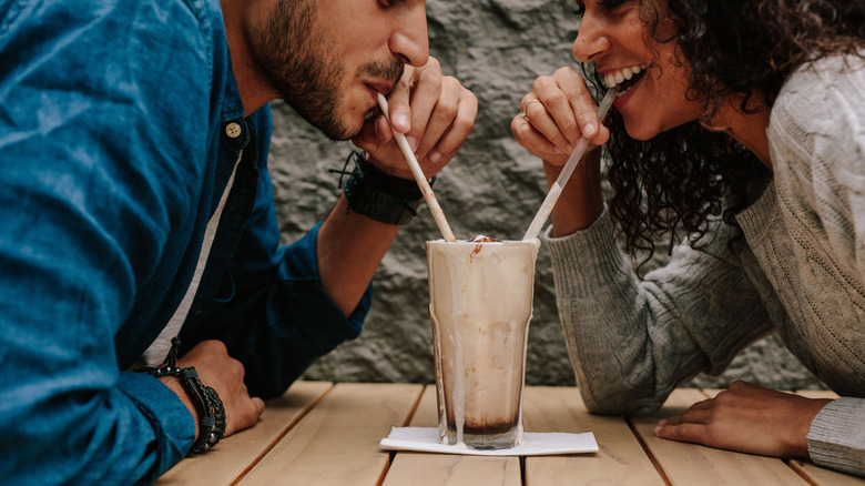 couple sharing a milkshake