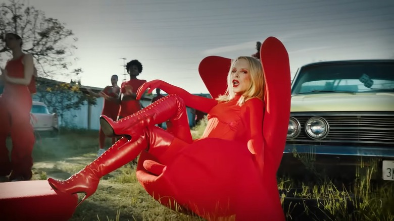 Kylie Minogue in a red leather outfit from the music video for Padam Padam