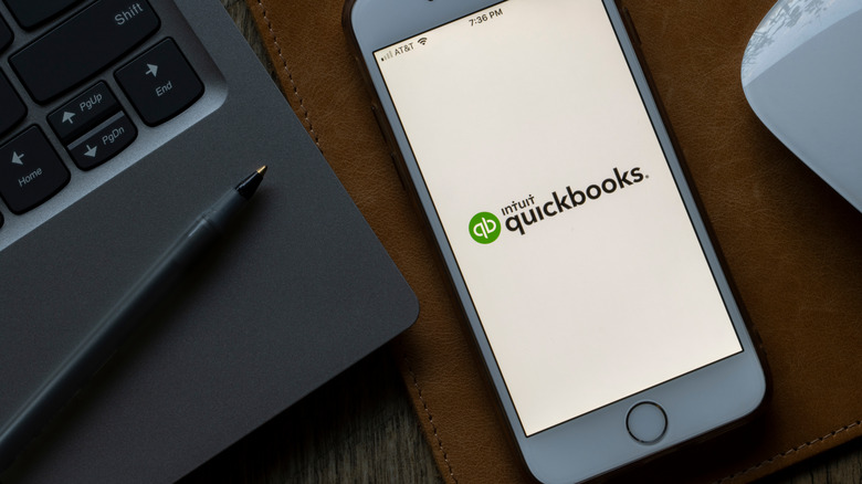 Quickbooks logo on mobile phone on desk