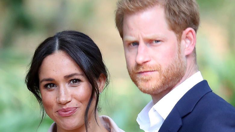 Prince Harry and Meghan Markle pose for a photo. 