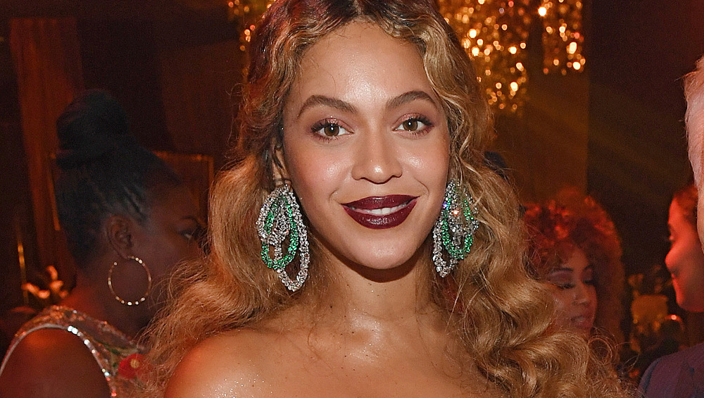 Beyonce smiling with statement earrings