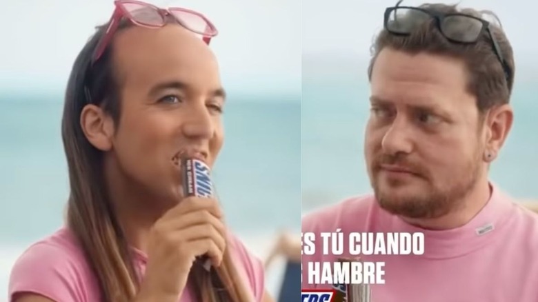 Two men eating snickers