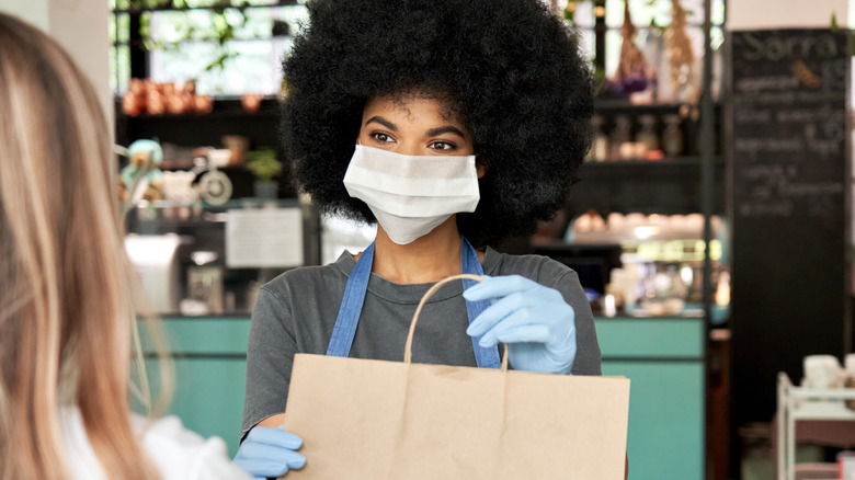 Young Black woman working at restaurant