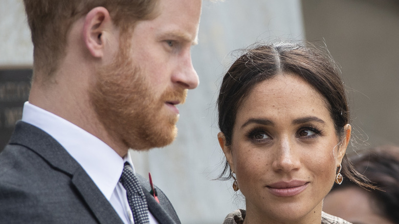 Meghan Markle looks knowingly at Prince Harry