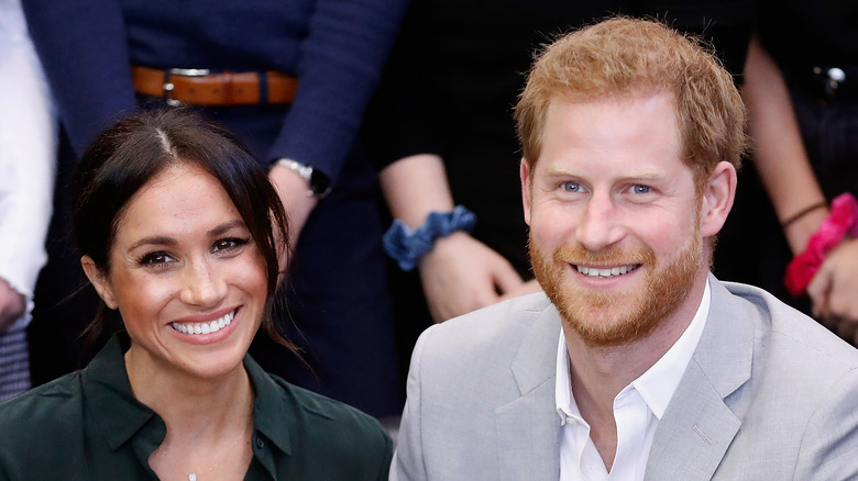 Meghan Markle and Prince Harry smile at an event