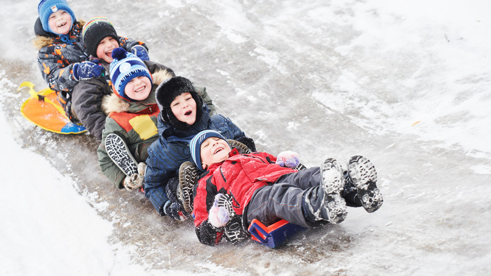 Children sledding in the snow