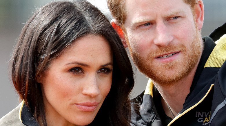 Prince Harry and Meghan Markle with their heads together