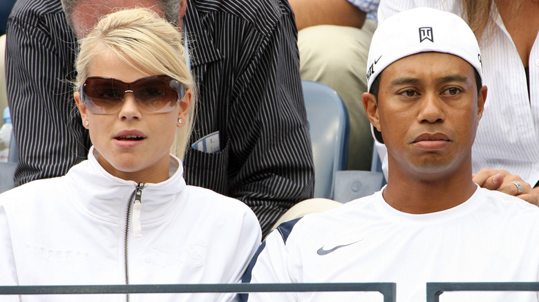 Elin Nordegren and Tiger Woods watching tennis