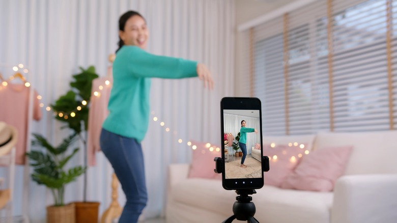young woman filming a video for social media 