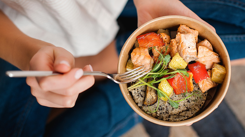 Woman holding sushi bowl