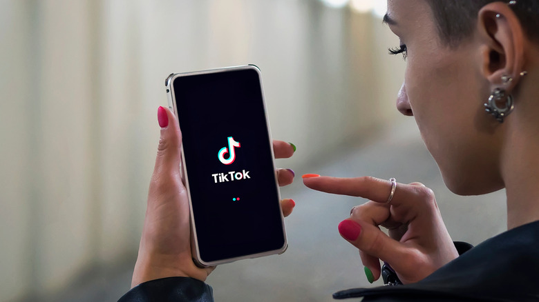 Woman using TikTok on her phone