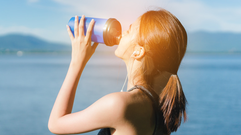 Woman drinking from blender bottle