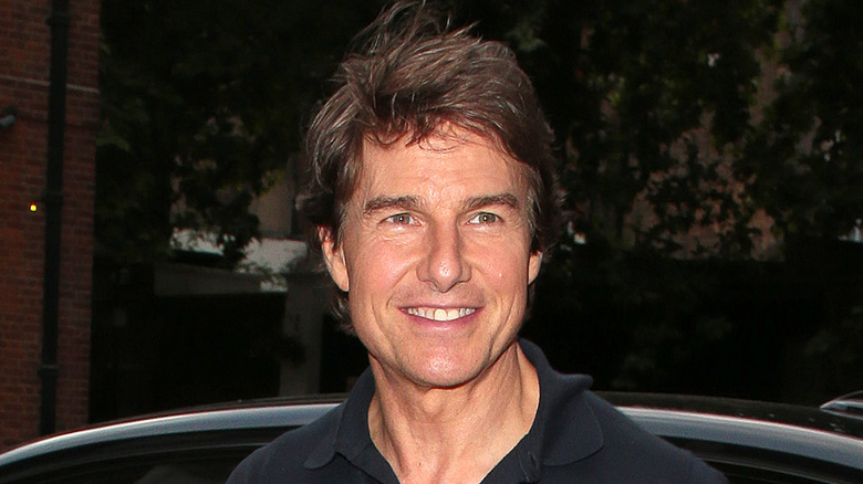 Tom Cruise smiles for a photo. 