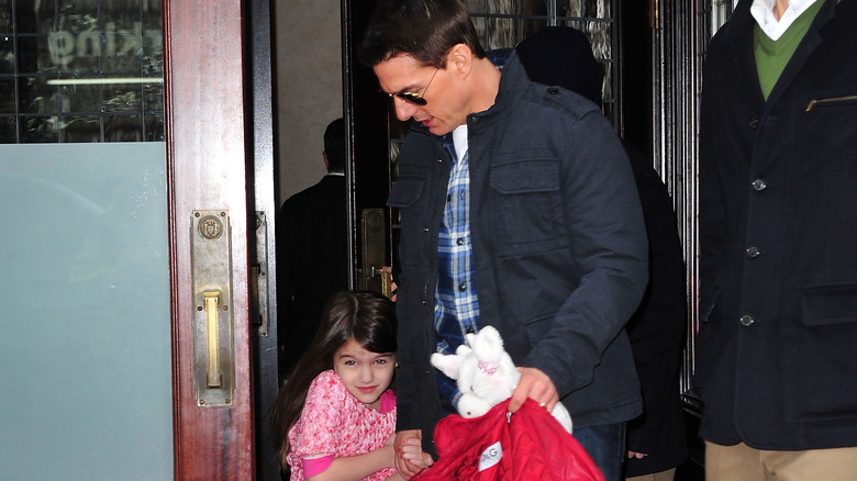 Tom Cruise heading out with a young Suri