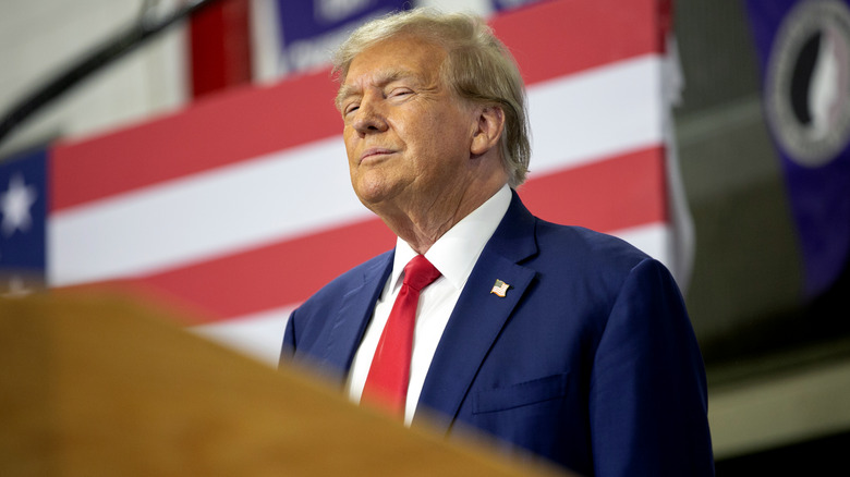 Donald Trump smiling at a podium