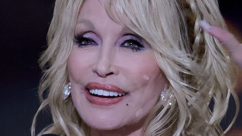 Dolly Parton grinning at the 2022 Academy of Country Music Awards