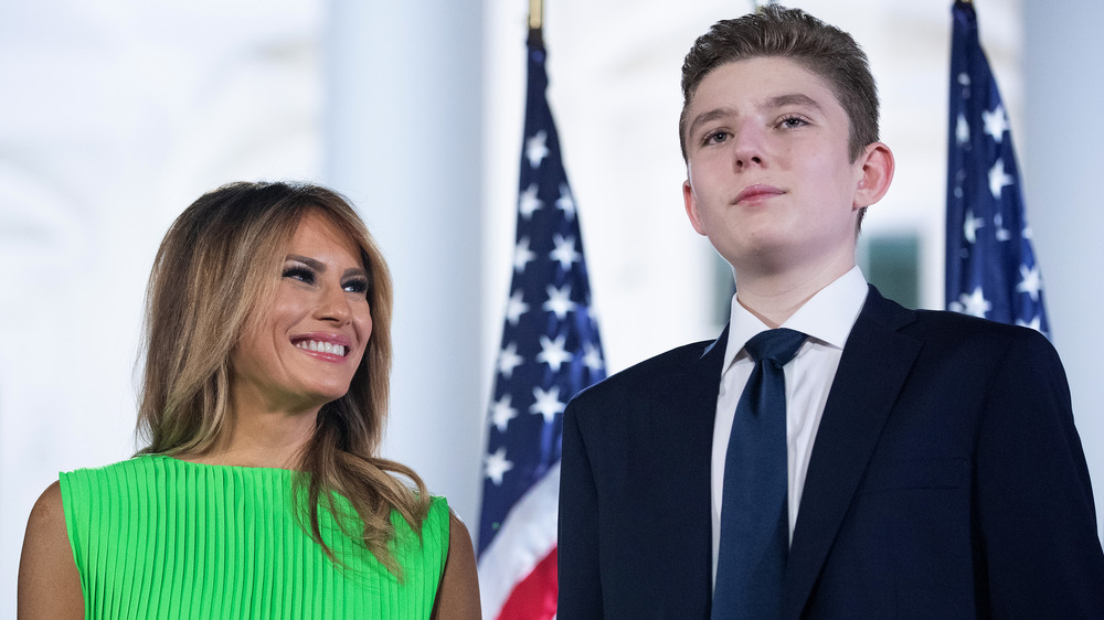 Barron Trump stands with Melania Trump