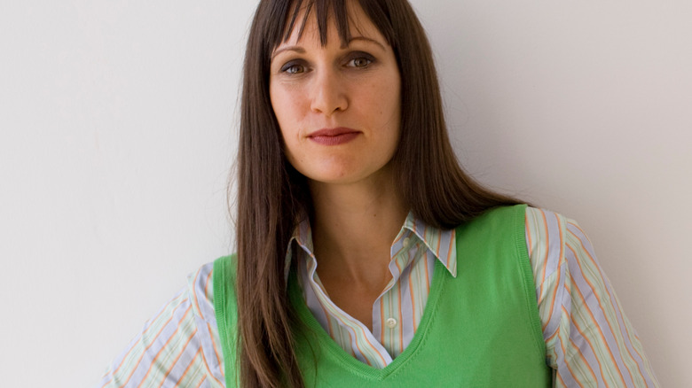 Woman wearing green sweater vest