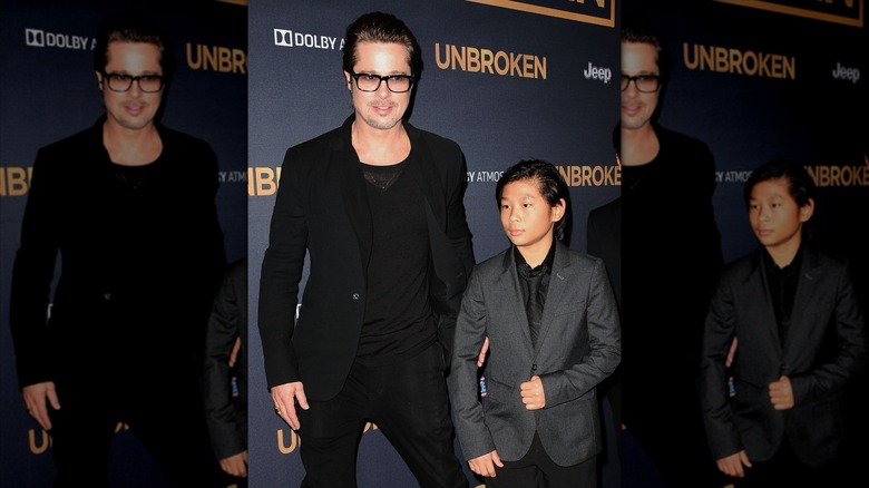 Brad Pitt stands with son Pax Jolie-Pitt at a premiere