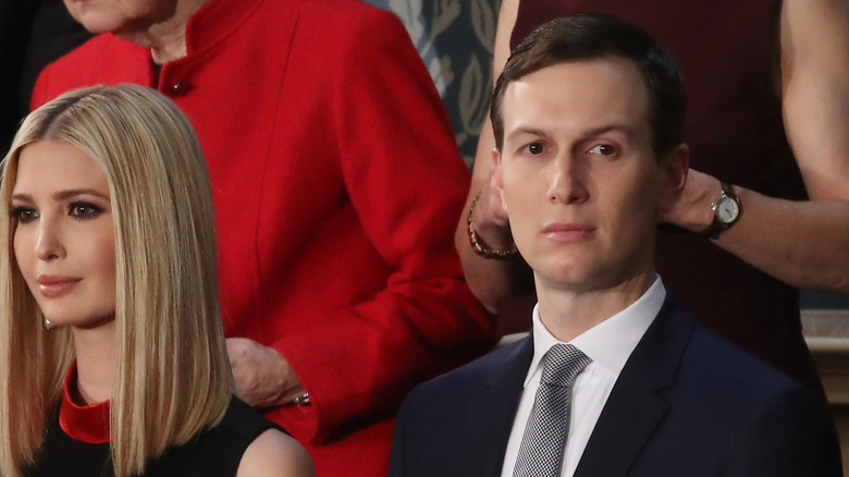 Ivanka Trump stands next to Jared Jushner at an event.