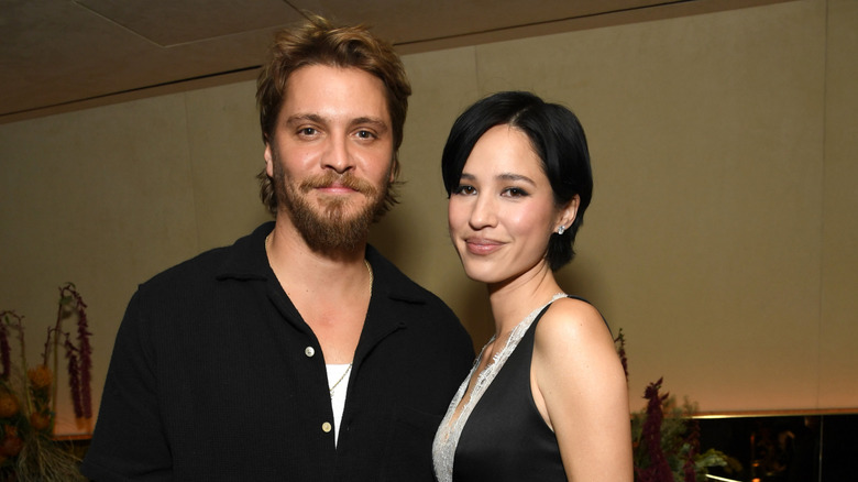 Luke Grimes and Kelly Asbille posing at an event