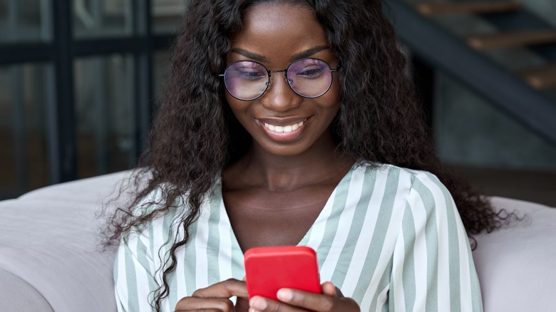 Woman smiling at phone