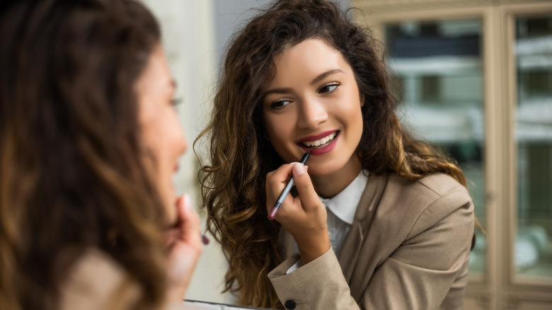 woman applying lip liner
